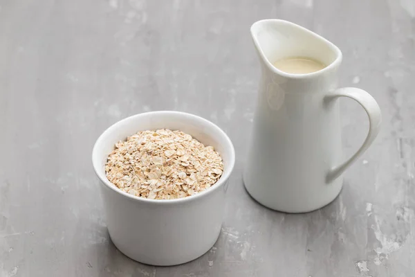 stock image Oat milk. Healthy vegan non-dairy organic drink with flakes on yellow