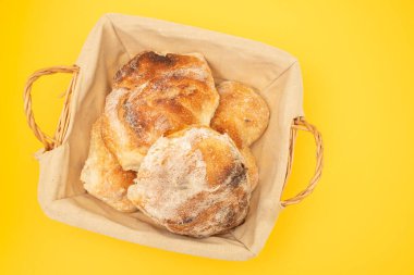 Taze ev yapımı birkaç ekmek sarı sepetin üzerinde.