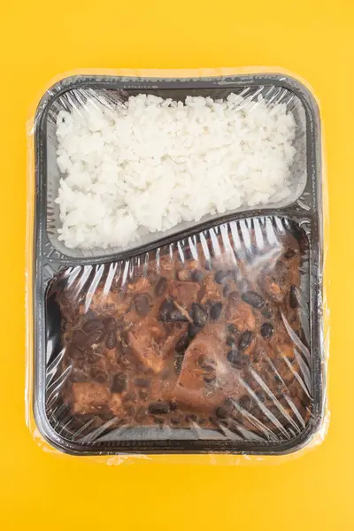 Feijoada typical Brazilian food. Traditional Brazilian food made with black beans. In plastic box.