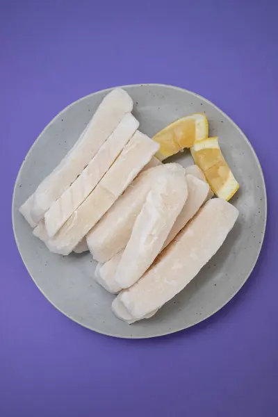 stock image Fresh frozen squid with lemon on plate