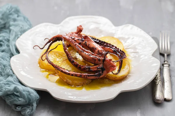 portuguese dish octopus with potato on big white plate