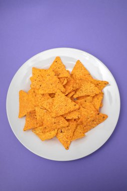 Beyaz tabakta portakallı Meksika cipsi.