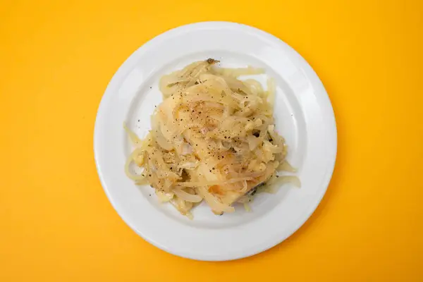Traditional portuguese cousine, cod fish onions with olive oil.