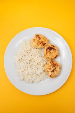 Kızarmış tavuk köftesi ve kaynamış pirinç.