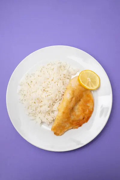 stock image Fried fish fillets with rice and lemon on white plate