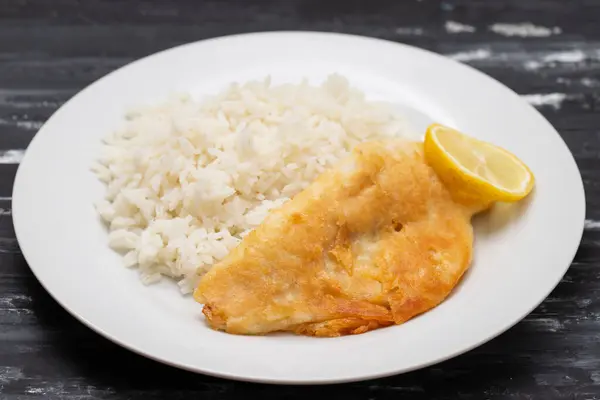 Stock image Fried fish fillets with rice and lemon on white plate