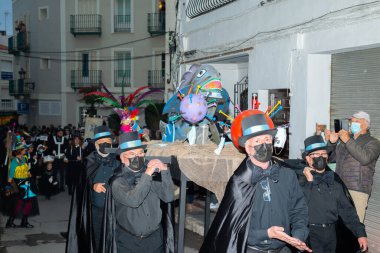 NERJA, SPAIN - 27 FEBRUARY 2022 A carnival parade that parodies a funeral procession and ends with the burning of a symbolic sardine figure