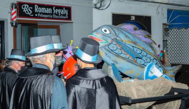 NERJA, SPAIN - 27 FEBRUARY 2022 A carnival parade that parodies a funeral procession and ends with the burning of a symbolic sardine figure
