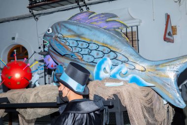 NERJA, SPAIN - 27 FEBRUARY 2022 A carnival parade that parodies a funeral procession and ends with the burning of a symbolic sardine figure