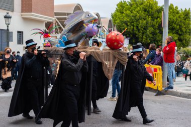 NERJA, SPAIN - 27 FEBRUARY 2022 A carnival parade that parodies a funeral procession and ends with the burning of a symbolic sardine figure