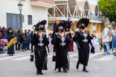 NERJA, SPAIN - 27 FEBRUARY 2022 A carnival parade that parodies a funeral procession and ends with the burning of a symbolic sardine figure