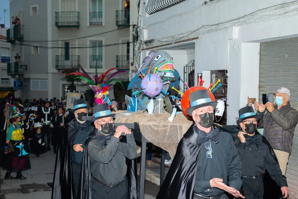 NERJA, SPAIN - 27 FEBRUARY 2022 A carnival parade that parodies a funeral procession and ends with the burning of a symbolic sardine figure