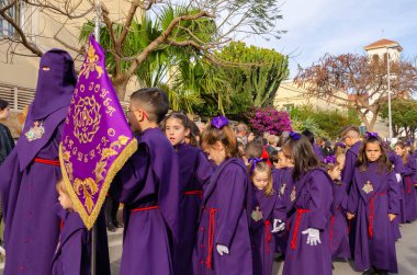 ALMERIA, İSPAN - Nisan 06, 2023 Kutsal Hafta 'da insanların geçit töreni. Törene katılan sakinler üzerinde azizlerin resimleri olan platformlar giyerler.