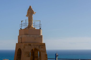 ALMERIA, SPAIN - 23 FEBRUARY 2024 White marble statue of the Sacred Heart of Jesus on one of the best panoramic views of the city of Almeria in Spain clipart