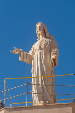 ALMERIA, SPAIN - 23 FEBRUARY 2024 White marble statue of the Sacred Heart of Jesus on one of the best panoramic views of the city of Almeria in Spain clipart