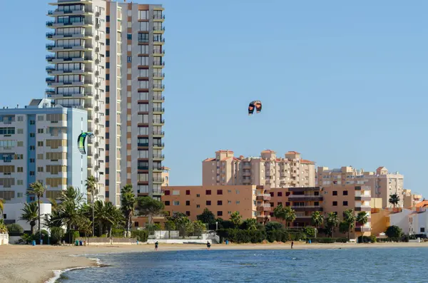 LA MANGA, İspanya - 27 Şubat 2019 İspanya 'nın La Manga kentindeki sığ bir gölde uçurtma sporu yapan insanlar