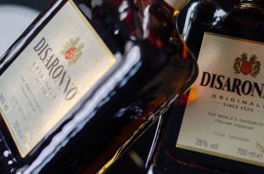LONDON, UK - 17 APRIL 2024 Bottles of Disaronno Originale, an amber colored liqueur with a characteristic almond flavour clipart