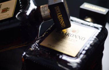 LONDON, UK - 17 APRIL 2024 Bottles of Disaronno Originale, an amber colored liqueur with a characteristic almond flavour clipart