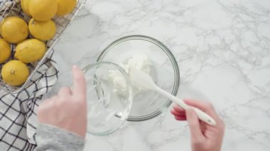 Time lapse. Step by step. Flat lay. Mixing ingredients into the batter for lemon pound cake.