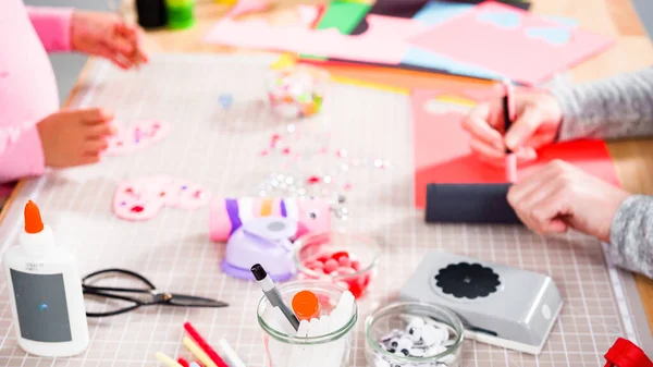 stock image Kids papercraft. Making paper bugs out of the empty toilet paper rolls and construction paper.