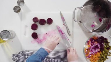 Düz yatıyordu. Adım adım. Sirkeli salata için beyaz bir kesme tahtasındaki sebzeleri dilimliyorum..