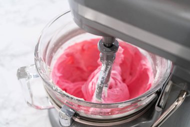 Mutfaktaki elektrikli mikserin içeriğini karıştırıp tereyağlı krema yapıyorum..