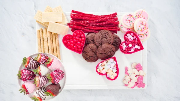 stock image Flat lay. Step by step. Cheese board with candies and cookies for Valentines Day.