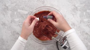 Düz yatıyordu. Adım adım. Kırmızı kadife kek hazırlamak için karıştırma kabındaki malzemeleri karıştırıyorum..