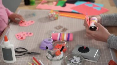 Close up view. Kids papercraft. Making paper bugs out of the empty toilet paper rolls and construction paper.