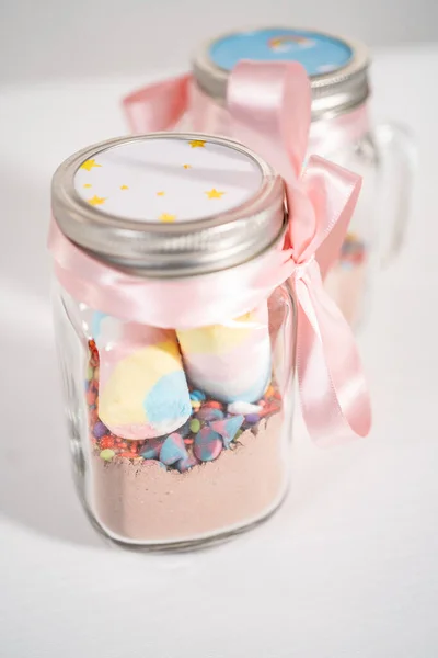Making unicorn hot chocolate mix in drinking mason jar as a food gift.