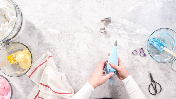 Flat lay. Step by step. Transfering meringue mix into piping bags with metal tips to bake unicorn meringue pops cookies.