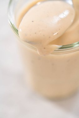 Mutfak tezgahında cam kavanozda ev yapımı İsveç köftesi sosu..