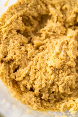 Mixing ingredients with a hand mixer to bake chocolate cookies with chocolate hearts for Valentines Day.