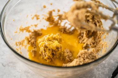 Büyük bir bardaktaki malzemeleri mutfak mikseriyle karıştırıp çikolatalı kurabiyeleri naneli cipsle pişirmek..