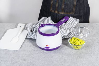 Çikolata parçacıkları eriyip, havuç kaplı kraker yapmak için şeker tenceresinde eritmek..