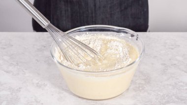 Adım adım. Hindistancevizli muzlu krep hazırlamak için cam karıştırma kabında malzemeleri karıştırıyorum..