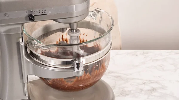 Step by step. Whipping chocolate ganache with an electric kitchen mixer.
