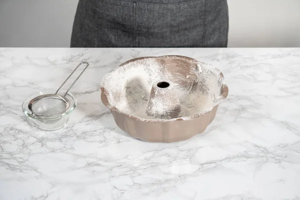 stock image Greasing metal bundt baking pan to bake bundt cake.