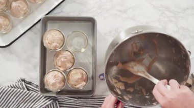 Düz yatıyordu. Adım adım. Ev yapımı çikolatalı dondurmayı cam kavanozlara koymak..