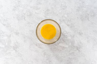 Flat lay. Mixing ingredients in a large glass mixing bowl to bake chocolate cookies with peppermint chips.