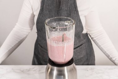 Mutfak blendırında sağlıklı kahvaltı için muz suyu karışımı karışımı..