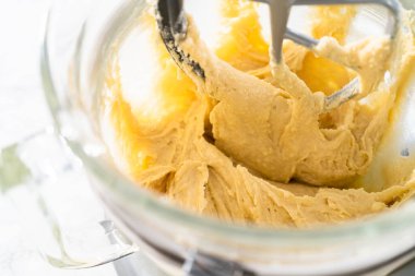 Mixing ingredients in kitchen electric mixer to bake American flag mini cupcakes.