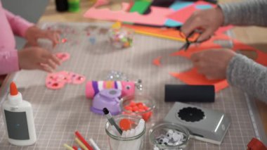 Close up view. Kids papercraft. Making paper bugs out of the empty toilet paper rolls and construction paper.