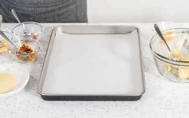 Pişmemiş kahvaltılık börekleri yumurtalarla fırçalamak ve patates ve yumurta yıkamak..