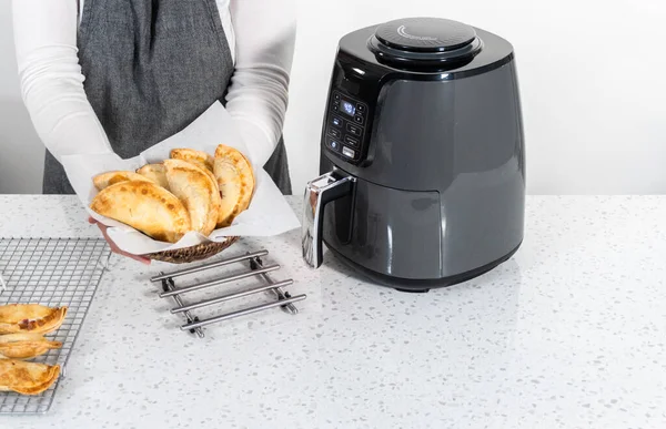 stock image Frying sweet cherry empanadas in the air fryer.