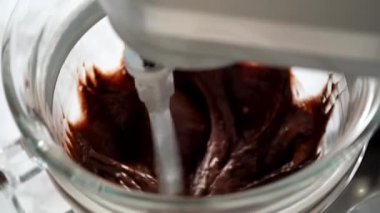 Mixing ingredients in kitchen mixer to bake a chocolate cupcake.