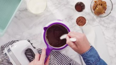 Time lapse. Flat lay. Step by step. Melting chocolate chips to prepare homemade chocolate ice cream.