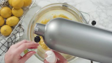 Time lapse. Step by step. Flat lay. Mixing ingredients into the batter for lemon pound cake.