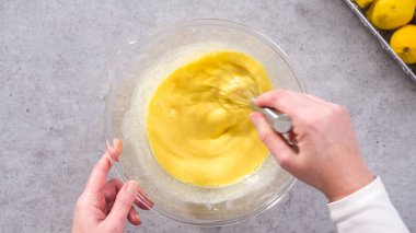 Düz yatıyordu. Adım adım. Limonlu kek hazırlamak için karıştırma kabının içindeki malzemeleri karıştırıyorum..