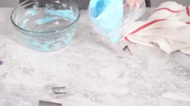 Time lapse. Step by step. Transfering meringue mix into piping bags with metal tips to bake unicorn meringue pops cookies.